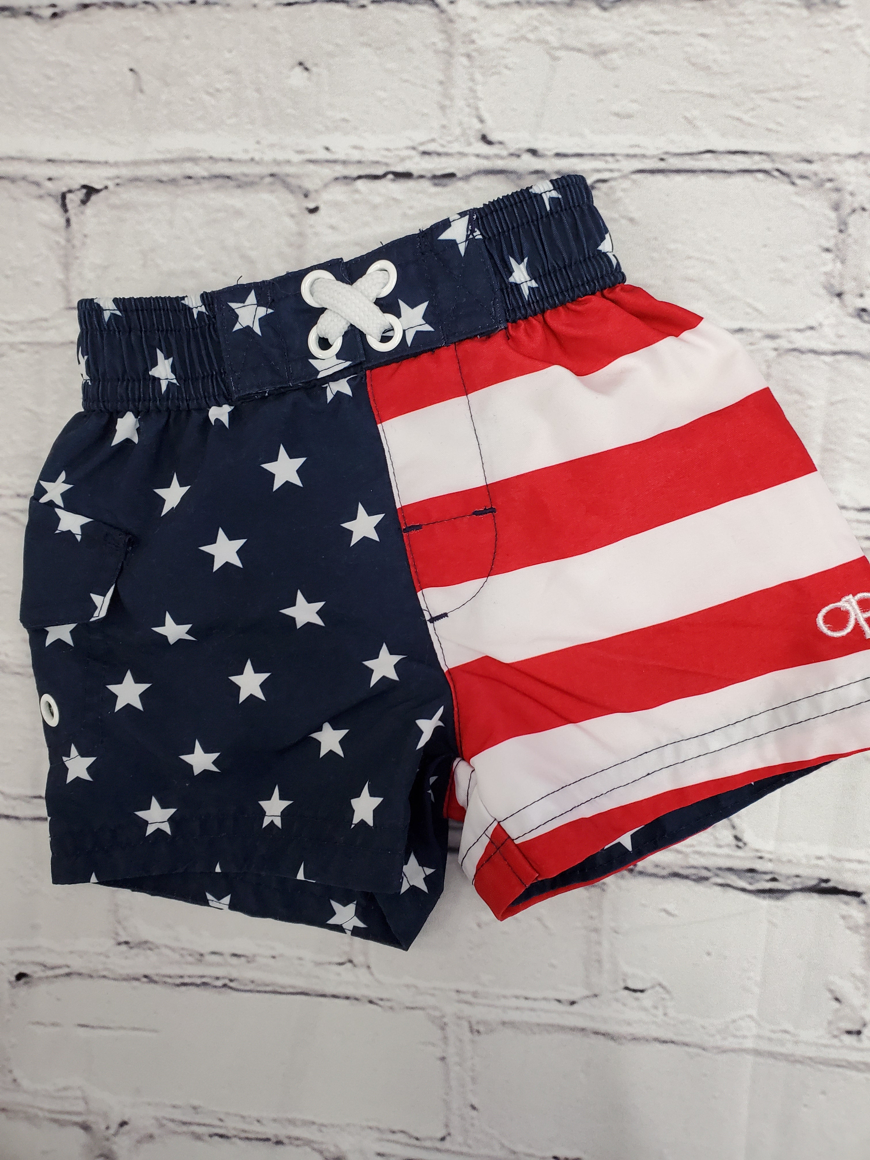 OP baby boys red white and blue swimming trunks sz3-6 m